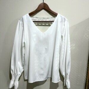 White V-neck blouse with lace back detail